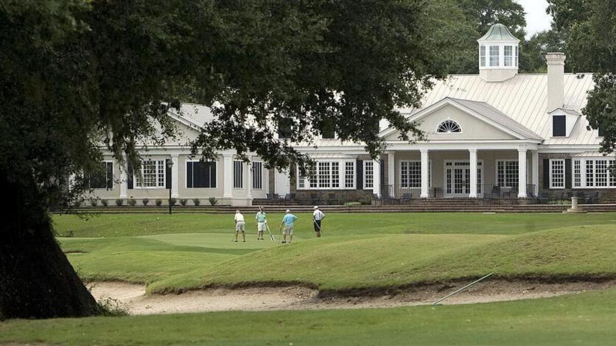 A group finishes on the 18th green at Pawleys Plantation on Monday, July 30, 2012.