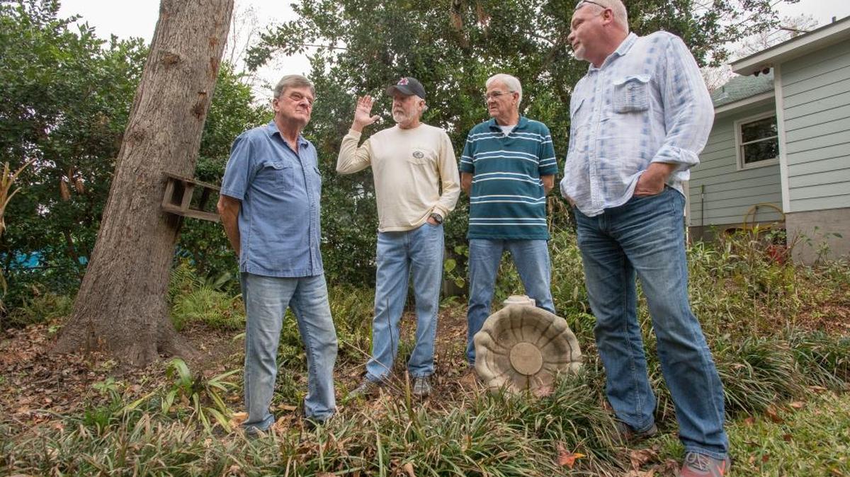 Jim Martin, Keith Lyons, Richard Paugh, and Richard Perdue stand outside Martin’s home where a tree fell on his roof.