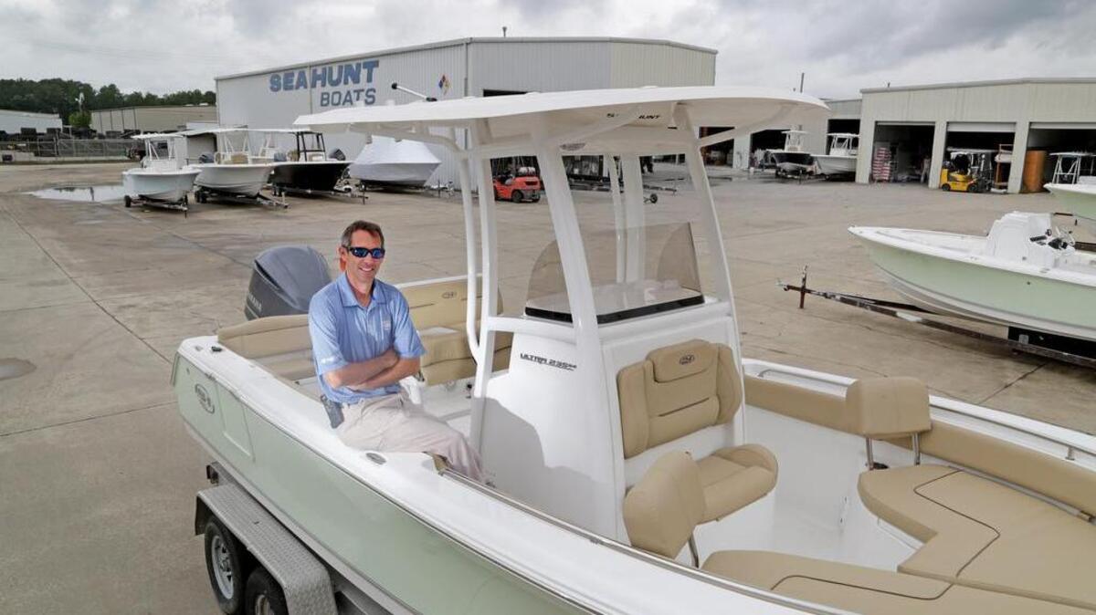 Sea Hunt Boat Co.’s Joel Moss sits inside an Ultra 235 SE fishing boat. The Columbia-based company is doing record sales after recovering from the recession.
