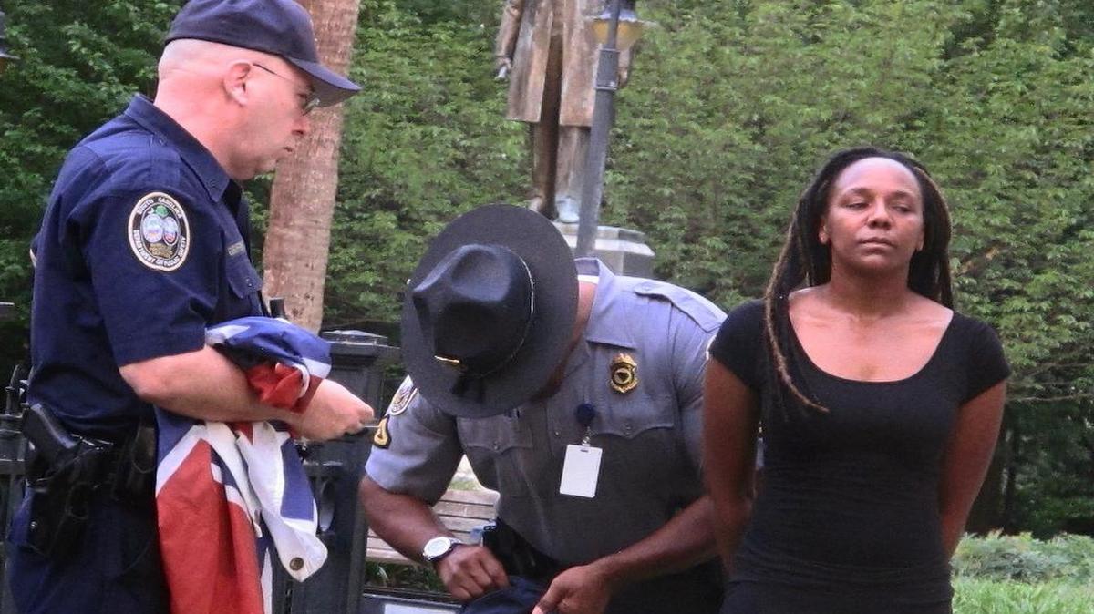 
Bree Newsome of Charlotte, right, is taken into custody after she removed the Confederate battle flag from a monument in front of the SC State House June 27 in Columbia. 
