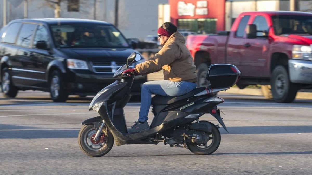 A mo-ped rider crosses at an intersection on U.S. 501 in Myrtle Beach. South Carolina lawmakers are considering strengthening regulations on the vehicles.