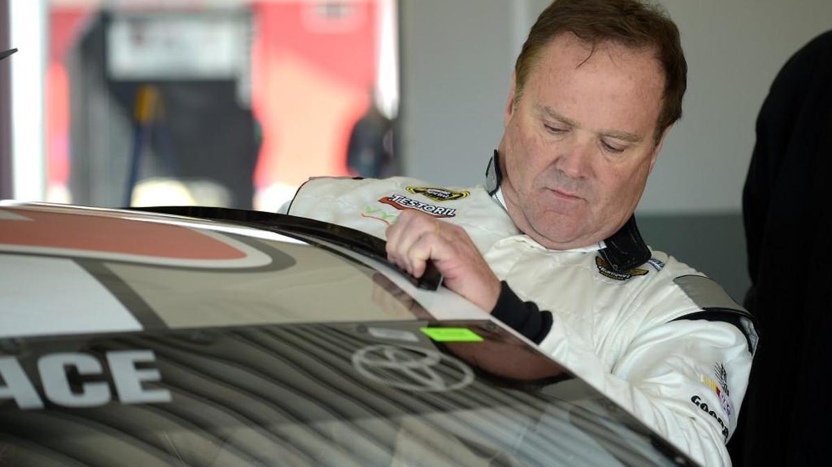 Driver Mike Wallace climbs into his car during a practice session for the Daytona 500 NASCAR Sprint Cup Series at Daytona International Speedway Feb. 14, 2015. Wallace and his daughter were attacked after leaving a concert Friday night.