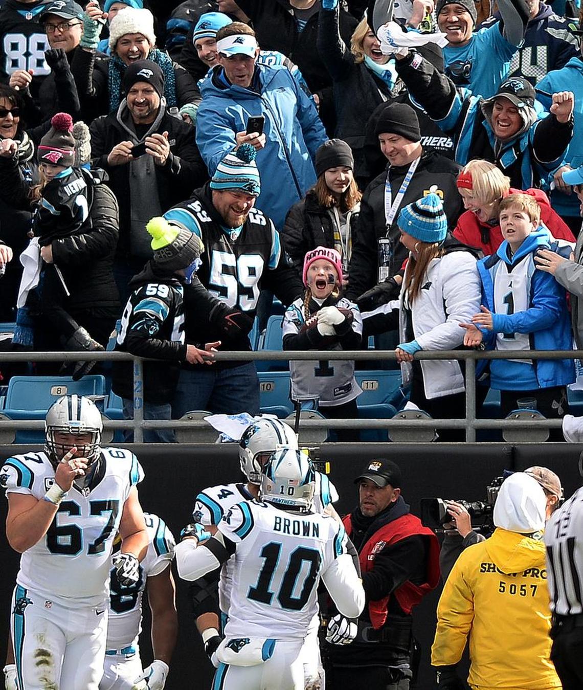 A stunned Isabella Bottomley, 8, reacts after Carolina Panthers running back Jonathan Stewart gave her the ball he’d carried into the end zone for the first touchdown against the Seattle Seahawks on Jan. 24, 2016.