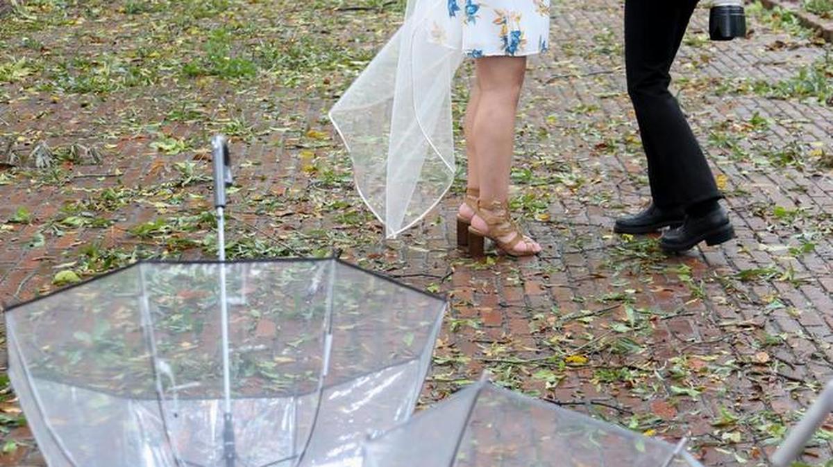 A blanket of fallen leaves and branches from recent rains brought into Columbia by Hurricane Matthew line the walkway at the University of South Carolina Horseshoe as wedding photographer Renee Ittner McManus works with Chelsea Rich after her wedding Saturday to Jared Rich at The Rutledge Chapel. The couple’s plans to wed in Bluffton were canceled because of Hurricane Matthew.