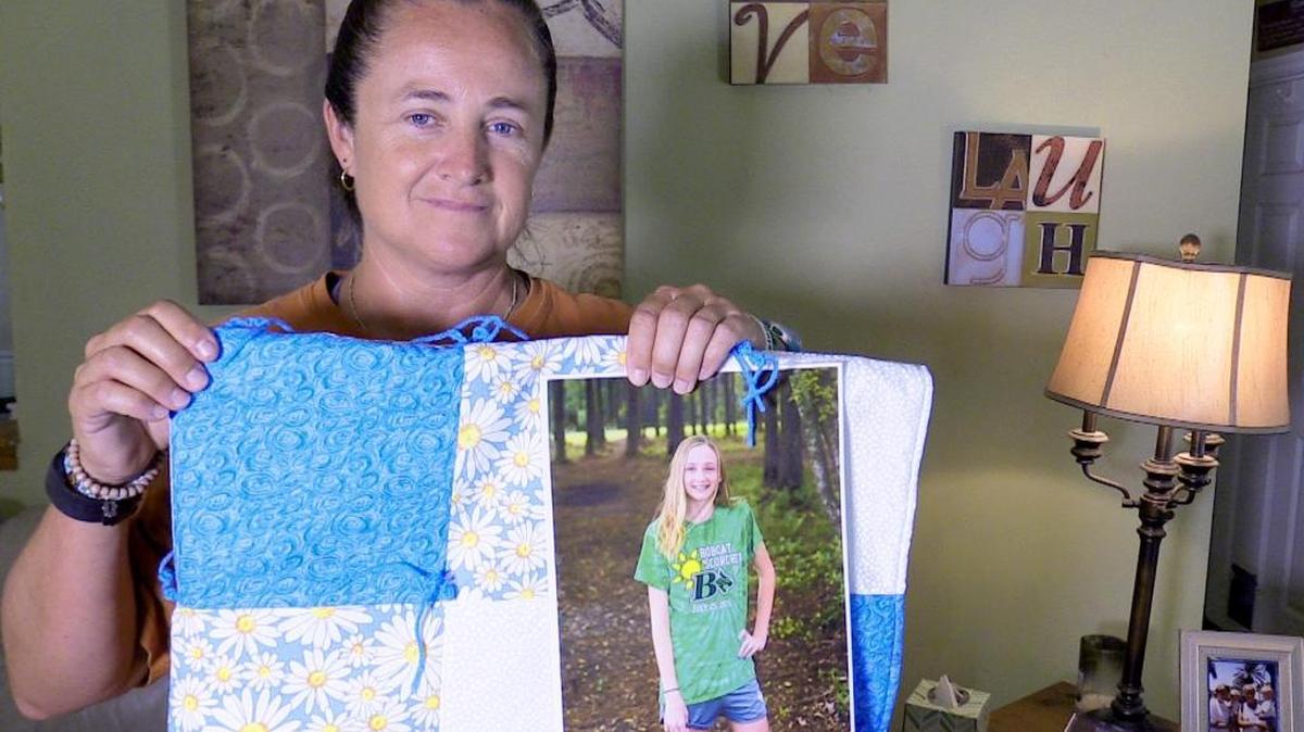 Heidi Hanson, mother of Grace Sulak, poses with a quilt on May 24, 2016, in their Bluffton home. The quilt was given to the family in remembrance of Hanson’s daughter, Grace. Grace Sulak, 14, died May 7 on eastbound I-26 in a hit-and-run wreck that injured driver Andrea Dewey and Dewey’s daughter, Emma Dewey, also 14 and Sulak’s best friend.