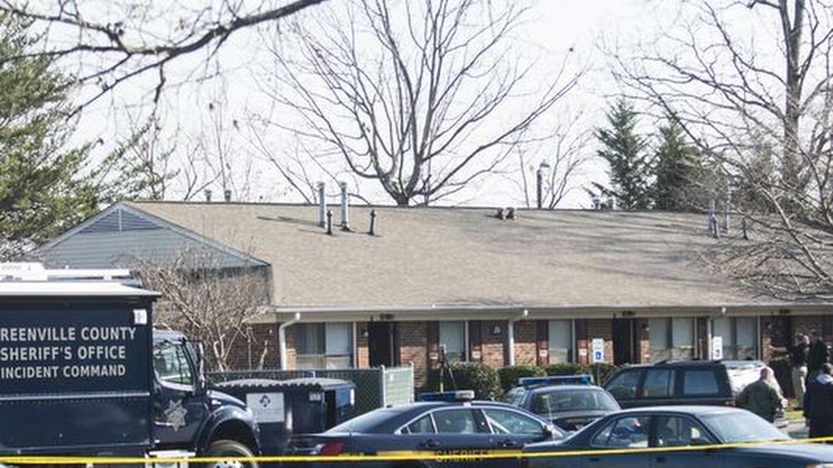 Neighbors and residents of Spring Grove Apartments pray over the violent situation that took place early Thursday morning when a Spring Grove Apartments resident was fatally shot after firing shots on two deputies of the Greenville County Sheriff's Office on Thursday, December 10, 2015 in Taylors.