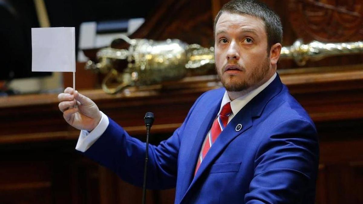 Rep. Christopher Corley, R-Aiken, shows his frustration by waving a white flag of surrender during debate over a Senate bill calling for the Confederate flag to be removed from the Capitol grounds in July.