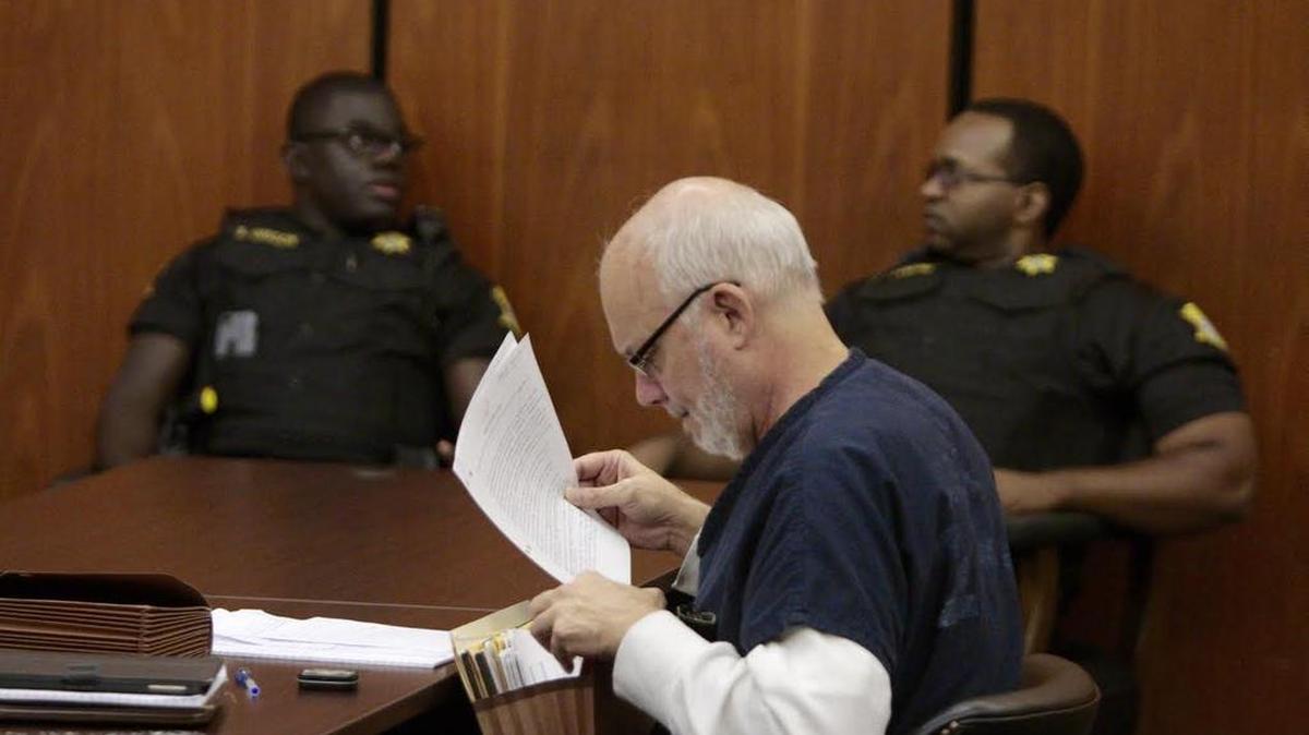 Chuck Sullivan looks at a file Wednesday during his commitment hearing in a Richland County courtroom.