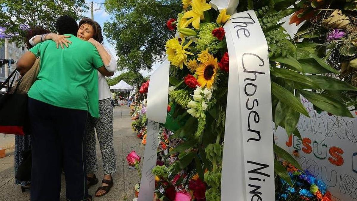 Dedra Marigault, left, and Maria Bornhorst console each other after Bornhorst became emotional visiting the sidewalk memorial at the ‘Mother’ Emanuel A.M.E. Church on Saturday, June 20, 2015, in Charleston, S.C.