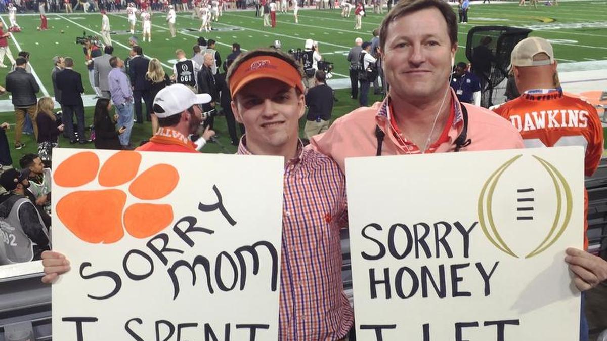 Scott Pyle (left) holds signs that went viral with his son, Dylan, at the NCAA National Championship football game in January in Arizona. Pyle is running for the S.C. Senate for a seat in Horry County.