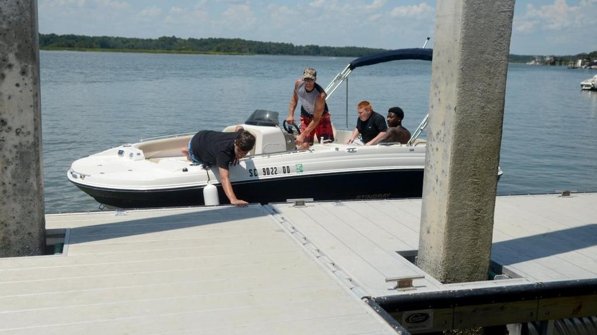 From left, Colton Segraves, 13, left, his father, Dean Segraves, and his friends R.J. Bennett, 13, and Memphis Daniels, 14, dock at the Bluffton Oyster Factory Park boat launch to wait for the rest of their party to park the car after launching July 14, 2016.