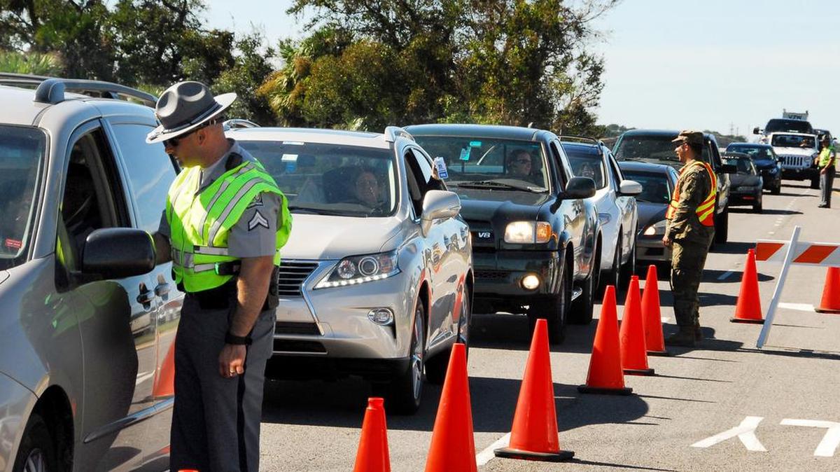 Cars line up at the Hilton Head Island checkpoint on Monday, Oct. 10, 2016 after Hurricane Matthew hit the southeast coast.