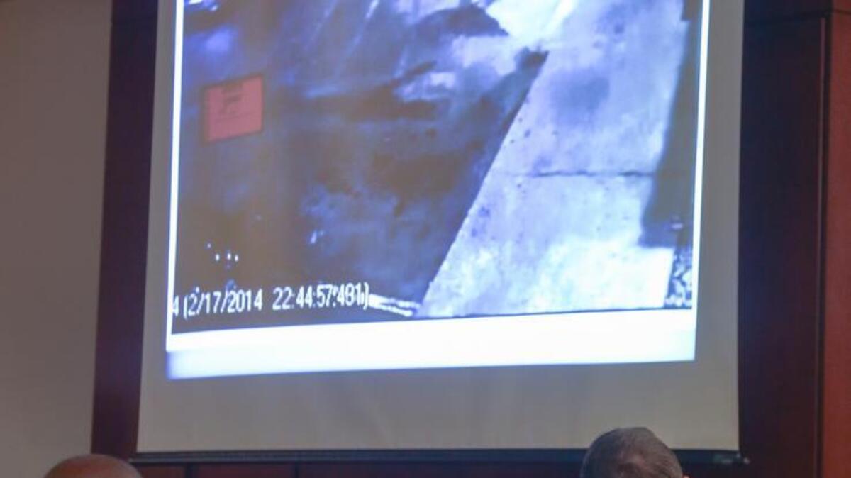 Kierin Dennis, with his attorneys, Todd Rutherford, left, and Ryan Volonis, looks at a still image taken from a video tape of the Cook Out parking lot in Lexington on the night of the stabbing death of Dutch Fork High School senior, Da'Von Capers.