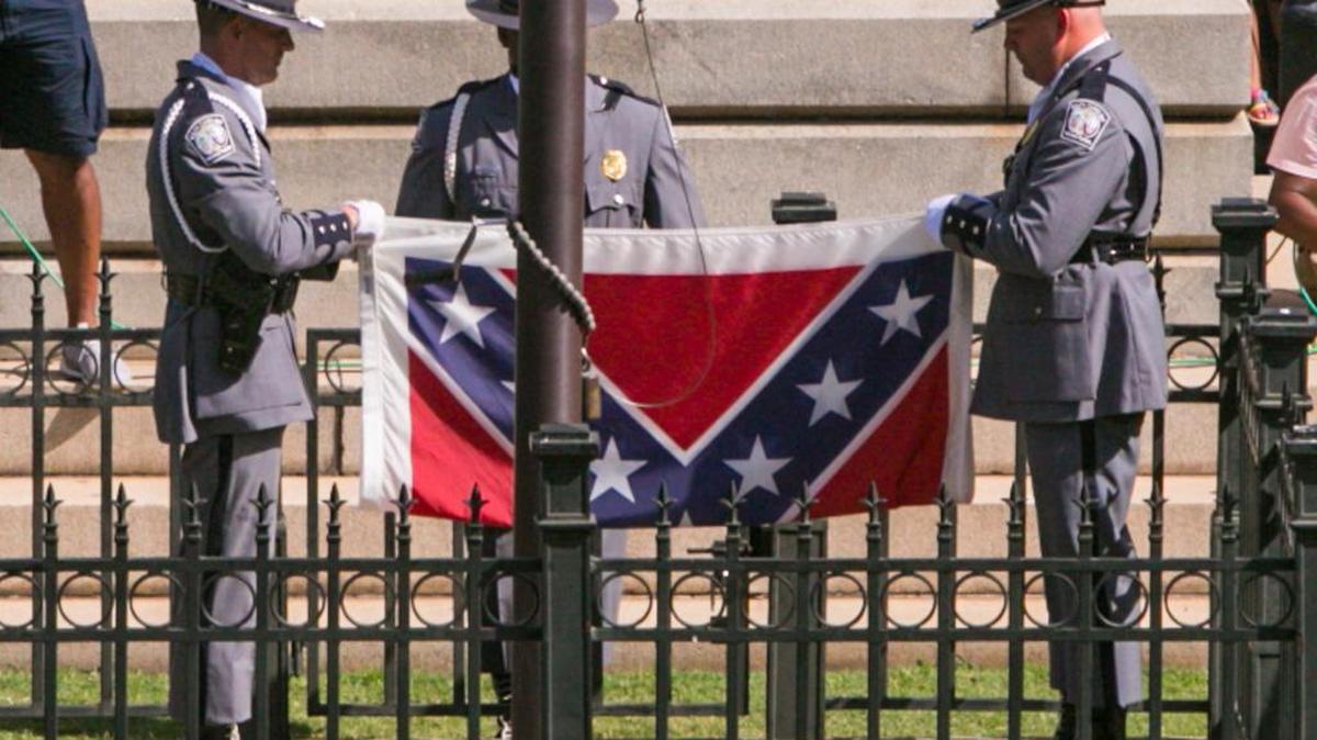 JULY 10, 2015 A large crowd gathered to watch the South Carolina Highway Patrol Honor Guard remove the Confederate Battle Flag from the State House grounds during a ceremony Friday.