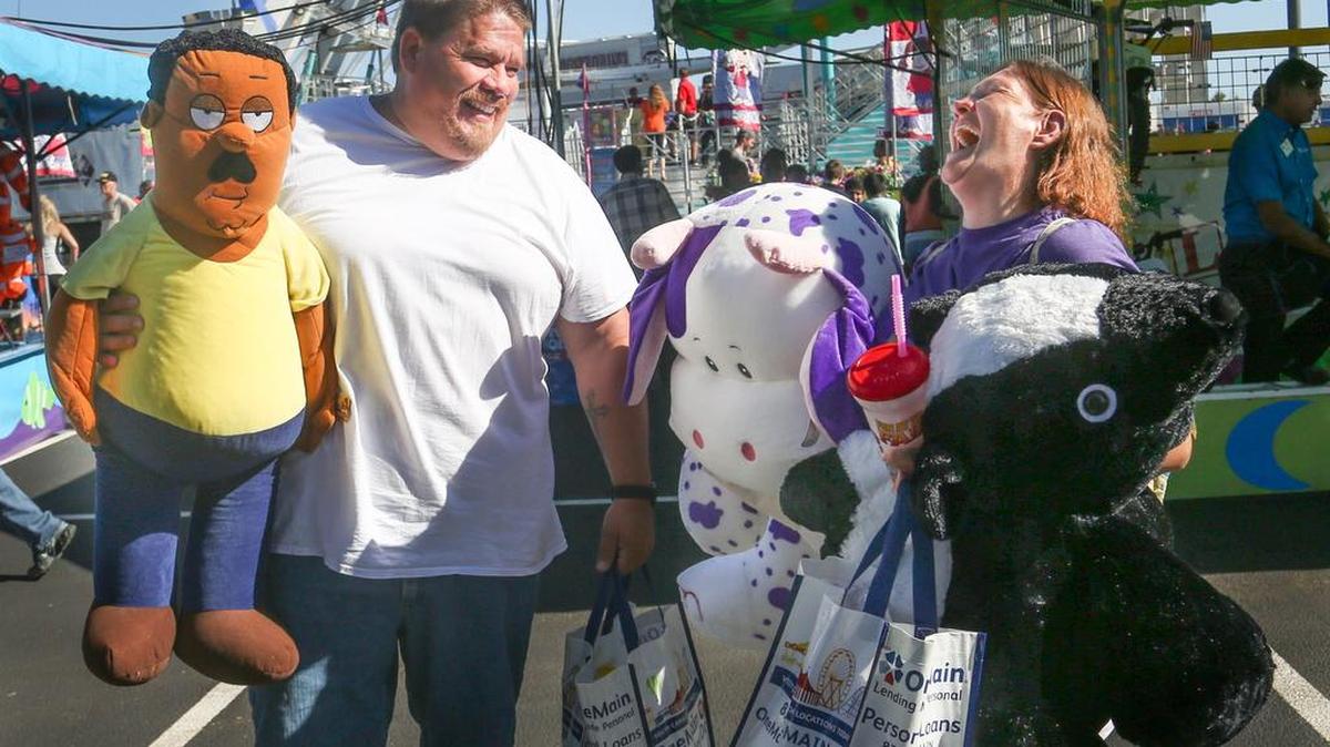 Mike and Teresa Teran of North, enjoy the fair atmosphere while waiting for their children, to ride rides on the first day of the South Carolina State Fair.