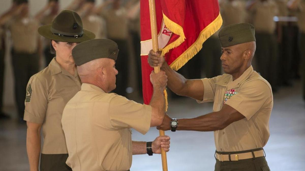 Outgoing Brig. Gen. Terry V. Williams, right, passes the Marine Corps colors to incoming Brig. Gen. Austin E. Renforth during the Change of Command ceremony Friday, June 10, 2016 at Marine Corps Recruit Depot Parris Island.