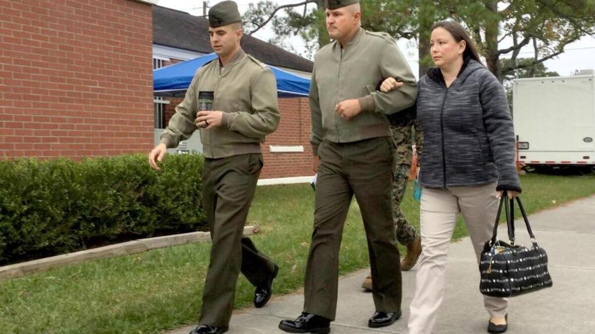 Gunnery Sgt. Joseph Felix, second from left, walks with his wife on Wednesday as he arrives for his hazing court-martial at Marine Corps Base Camp Lejeune, N.C.