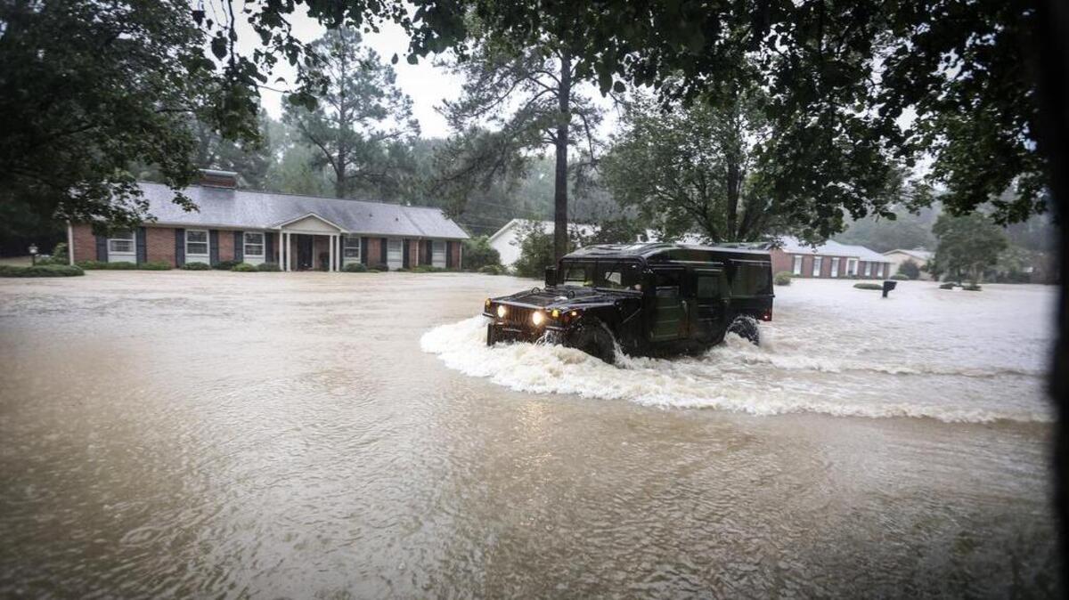 A national guard hummer drives down Carter Drive during a rescue in a Forest Acres neighborhood during flooding on Oct. 4, 2015.
