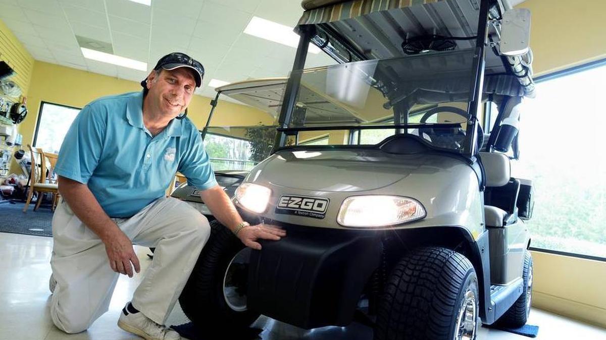 In this file photo from 2013, Bob Sutter, of Lowcountry Golf Cars, shows off an E-Z-GO golf cart equipped with headlights at the Okatie dealership.