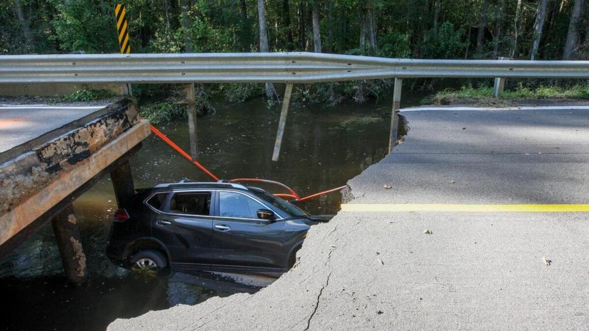 A car lies in Myers Creek in Hopkins Oct. 6 where the bridge on Lower Richland Boulevard collapsed.