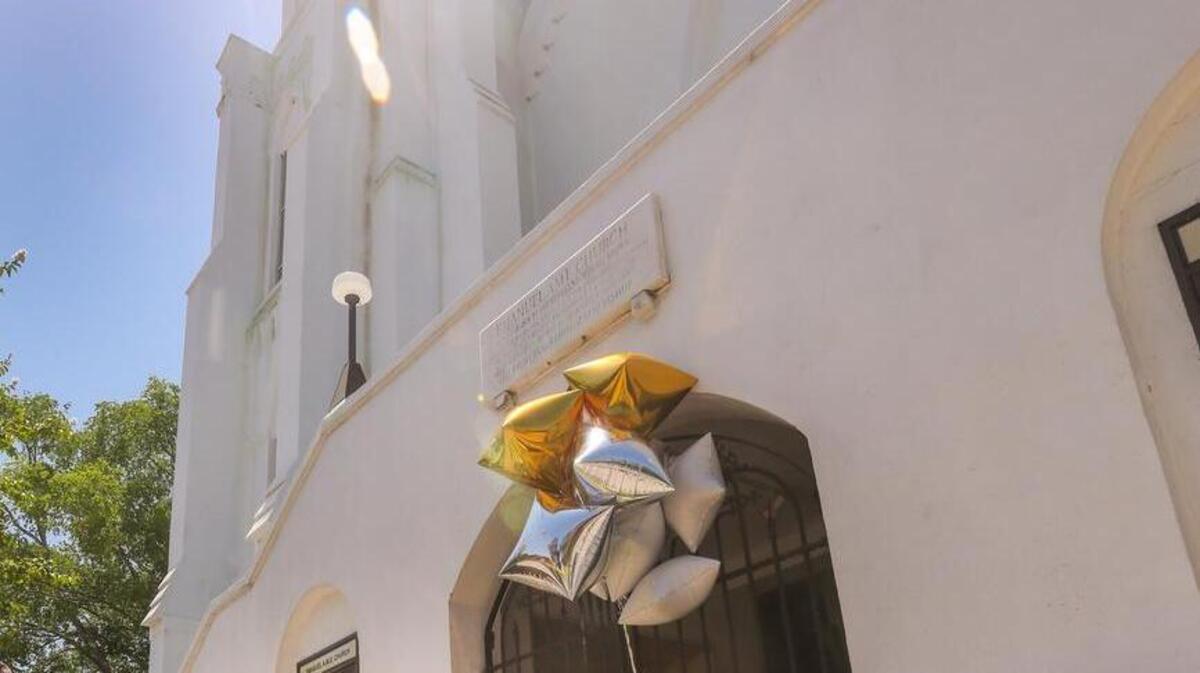 A stream of people brought flowers to the front of Emanuel AME Church in Charleston, where nine people were shot to death.