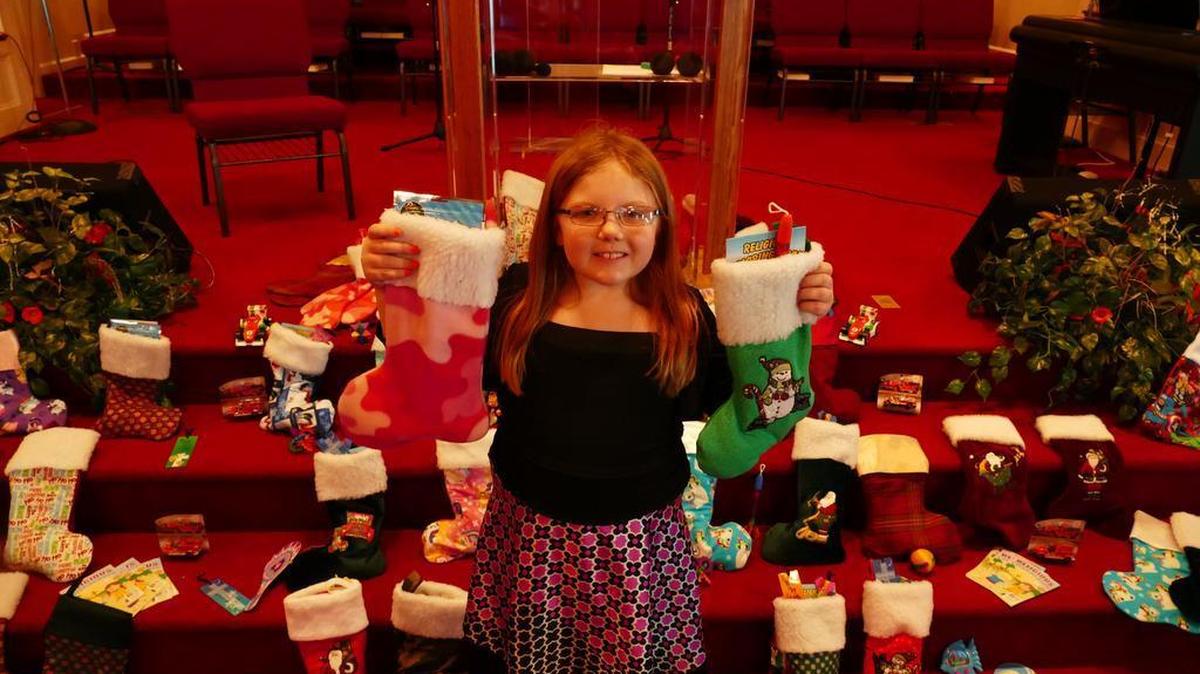 Destany Hubbard, 8, holds up two of the more than 150 stockings her grandmother made for patients at Levine Children’s Hospital in Charlotte. Destany goes to the hospital for a weekly shot and wanted to do something nice for the children who will be there at Christmas.