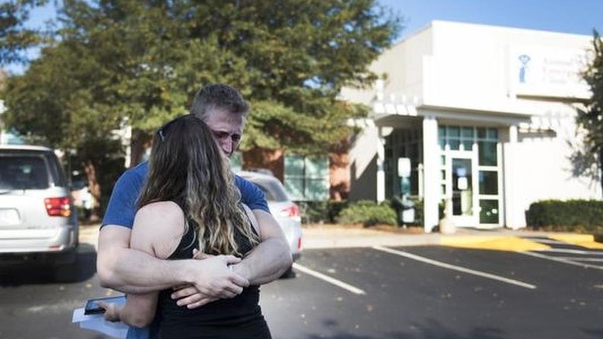 Misty Bridges and Matt Silsbee embrace outside of Animal Emergency Clinic as they get ready to pick up the body of their five-year-old Pomeranian on Monday, October 31, 2016.(Photo: LAUREN PETRACCA/Staff)