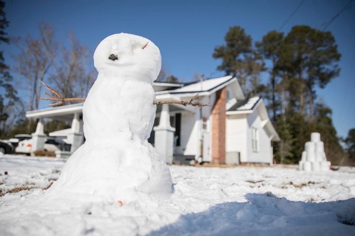 Jacob West, age 8, and his father Eric spent Thursday morning building a snowman and a fort in downtown Aynor. While much of the Grand Strand missed the heaviest snowfall from Winter Storm Grayson, residents of Aynor woke up to over three inches of snow on Thursday. Jan. 4, 2018.