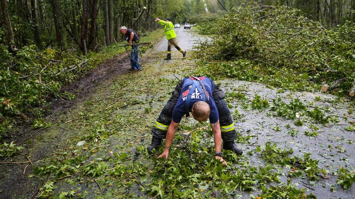 Columbia fire Capt. Jason Herbert, foreground, clears what’s left of a downed tree on Old Eastover Road Saturday. Herbert’s three-man crew cleared roads so that emergency vehicles could get through in the hard hit Lower Richland area.