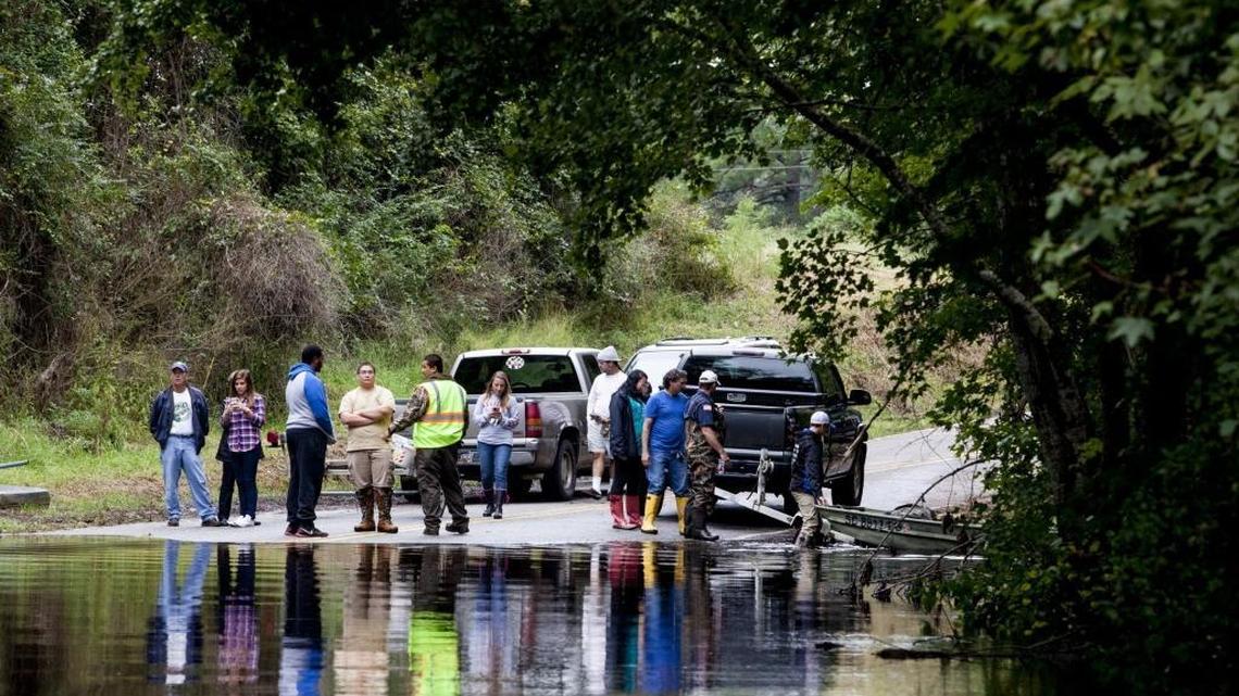
Residents wait on Pitch Landing road to learn about the damage to their properties. The Pitch Landing area of Conway continues to submerge with residents only able to access their homes with small boats. 
