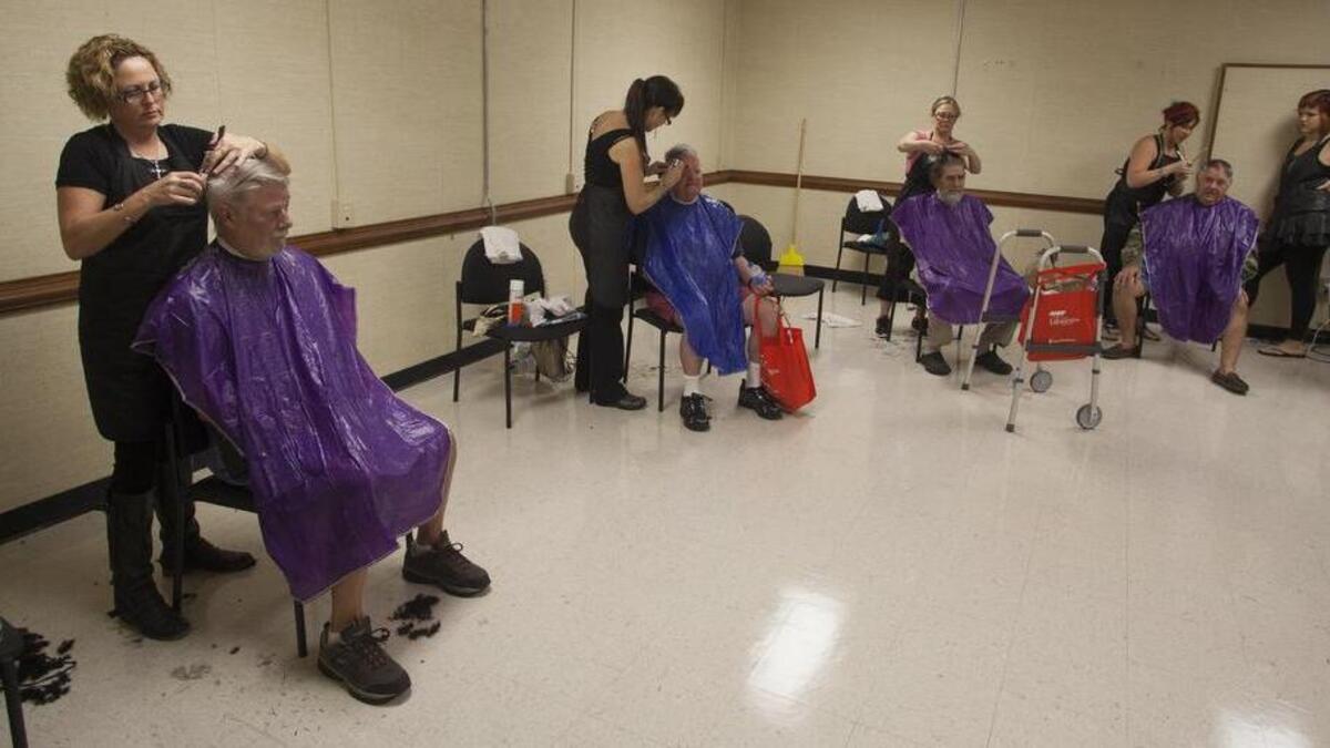 
Veterans get a free haircut provided by the stylists of Studio One Hair Designs of Longs during the 2014 Operation Stand Down Myrtle Beach. Members of local nonprofit organizations and AARP gathered at the U. S. Armory at 3392 Phillis Blvd. to connect with veterans and to provide services and information to more than 100 veterans. 
