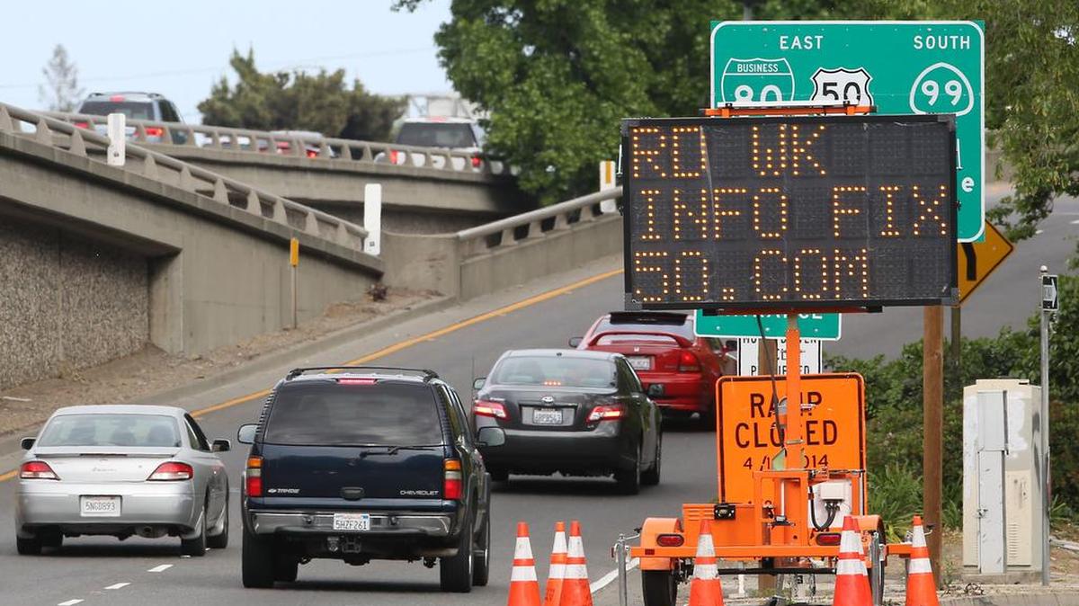 
In this April 21, 2014 file photo drivers using the onramp to eastbound Highway 50 pass a sign showing where to get information about the pending work on the freeway in Sacramento, Calif. 
