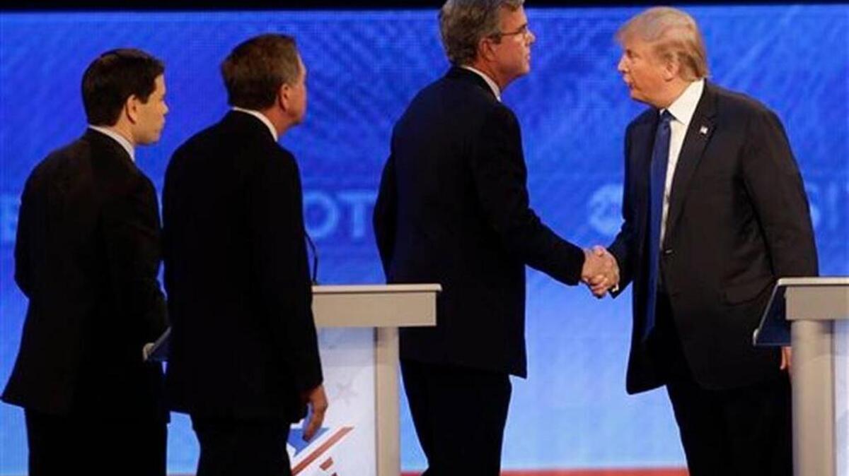 Republican presidential candidate Donald Trump shakes hands with fellow candidate, former Florida Gov. Jeb Bush, followed by Ohio Gov. John Kasich and, Sen. Marco Rubio, R-Fla. after a Republican presidential primary debate in Manchester, N.H.