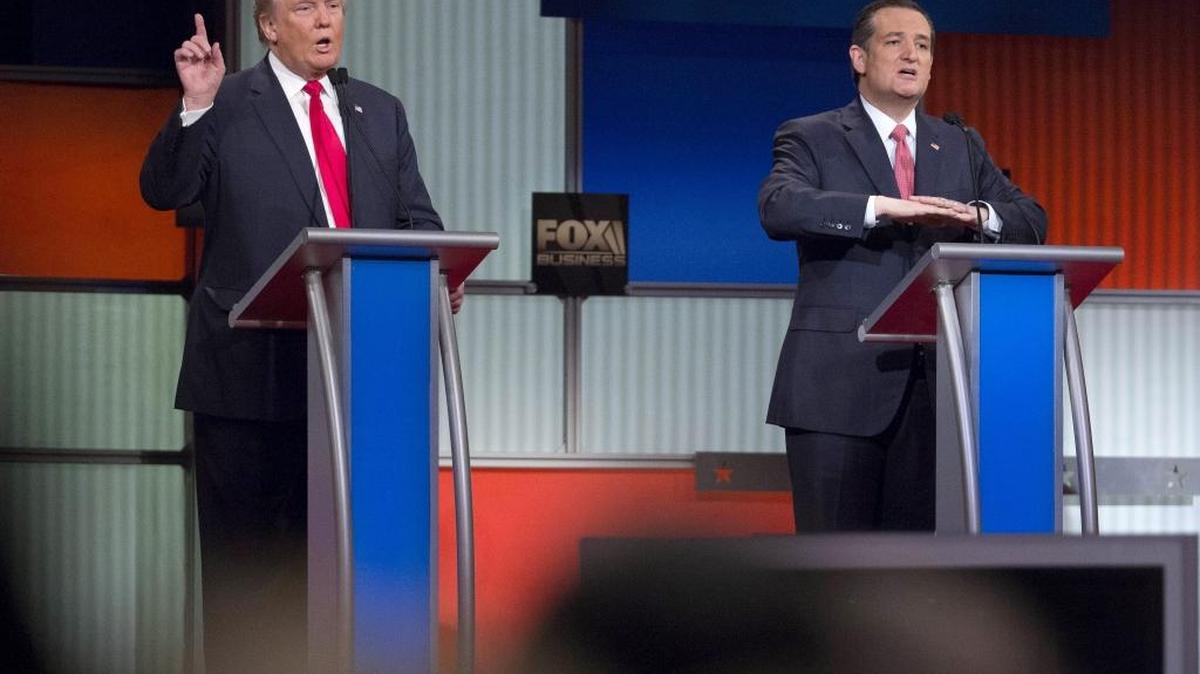 Republican presidential candidates Donald Trump (left) and Sen. Ted Cruz of Texas talk during the GOP candidate debate at the North Charleston Coliseum in North Charleston, South Carolina.