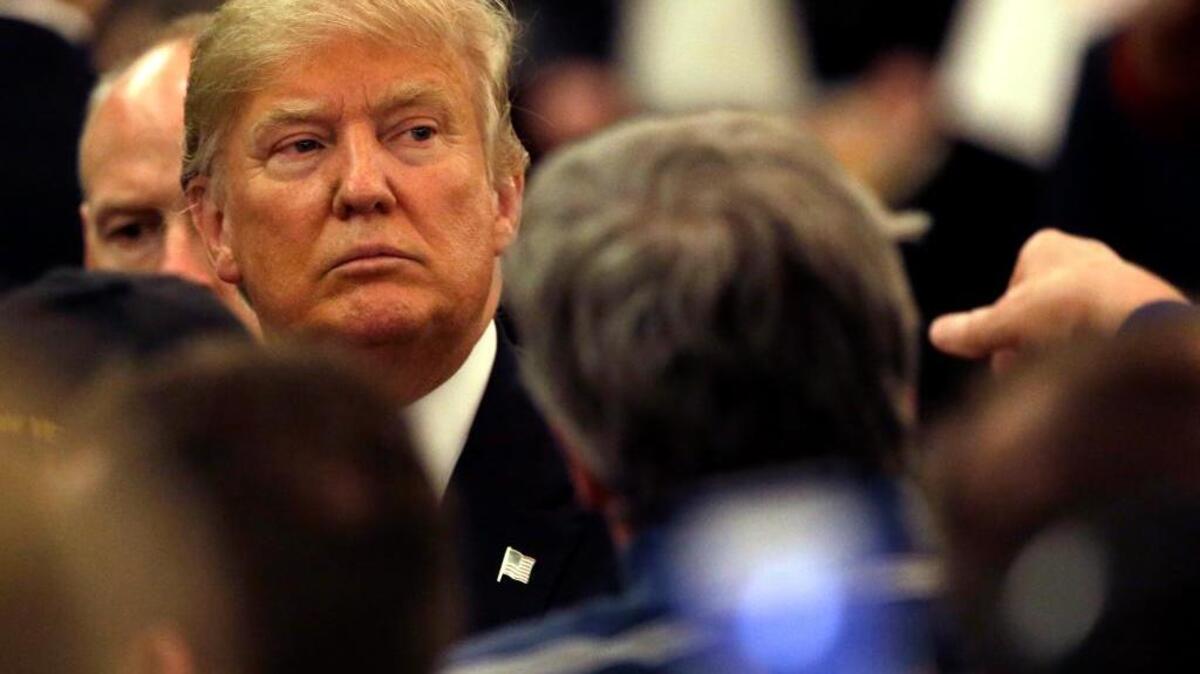 Republican presidential candidate Donald Trump looks to supporters as he leaves a campaign stop Wednesday, March 30, 2016, in Appleton, Wis.