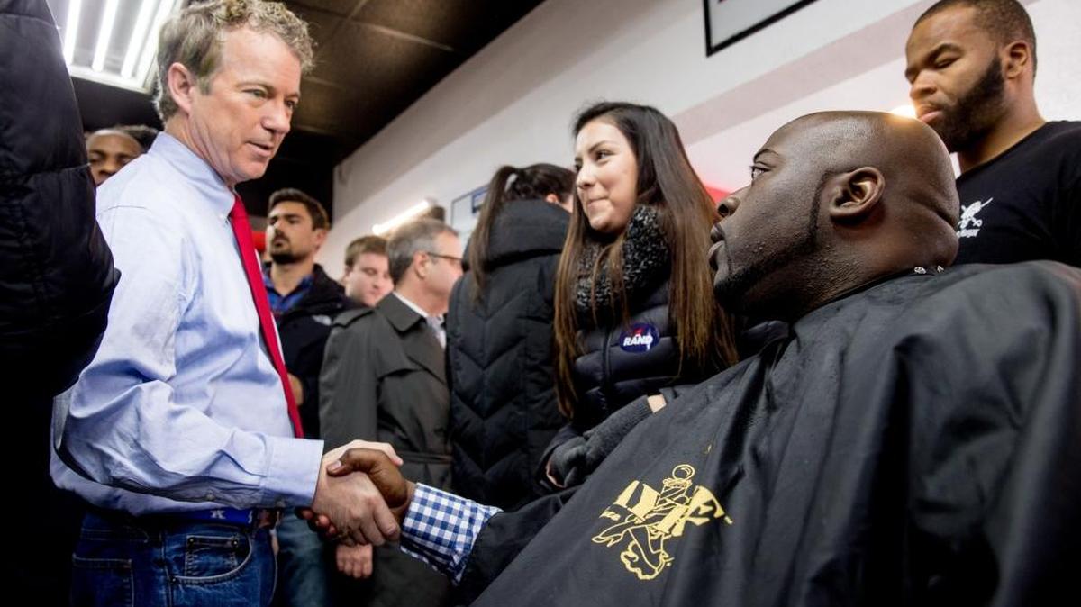 Republican presidential candidate Sen. Rand Paul, R-Ky., greets Rev. Robert Johnson of Waukee, Iowa, at Platinum Kutz barbershop in Des Moines, Iowa, Monday, Jan. 18, 2016.