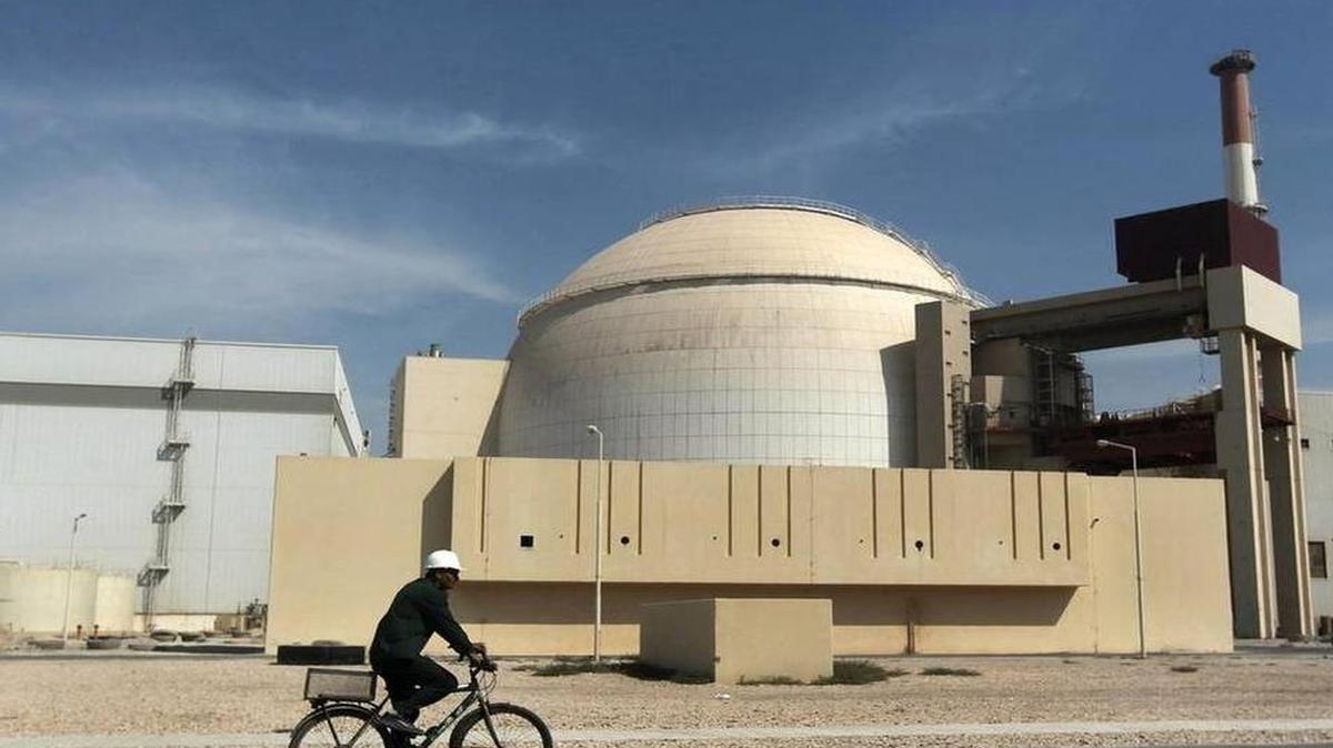 
In this Oct. 26, 2010 file photo, a worker rides a bicycle in front of the reactor building of the Bushehr nuclear power plant, just outside the southern city of Bushehr. | Majid Asgaripour AP
