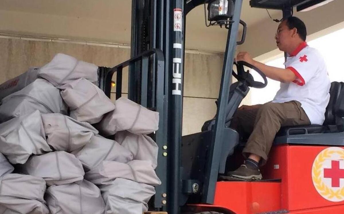 
A Red Cross worker operates a forklift carrying tents at a warehouse in Beijing Monday, April 27, 2015. The Chinese Red Cross shipped 2,000 tents by air to Kathmandu on Monday as part of its relief efforts for the earthquake in Nepal, which the agency said would be enough to shelter 10,000 to 12,000 people. | Isolda Morillo AP
