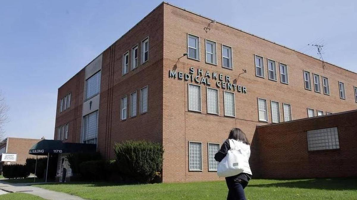 
A woman walks past the Center for Women’s Health in Cleveland on April 28. The facility was closed by its owner in fall 2013, and anti-abortion activists credited effects of a relatively new law limiting access to abortion if a fetus could survive outside the womb, saying the measure had cut into the facility’s business. | Tony Dejak AP
