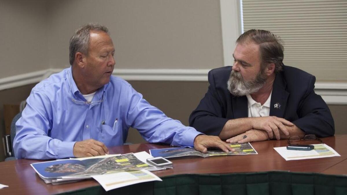 
Horry County Council Chair Mark Lazarus, left, and Horry County Councilman Marion Foxworth, right, look over traffic loop maps in this 2014 file photo.
