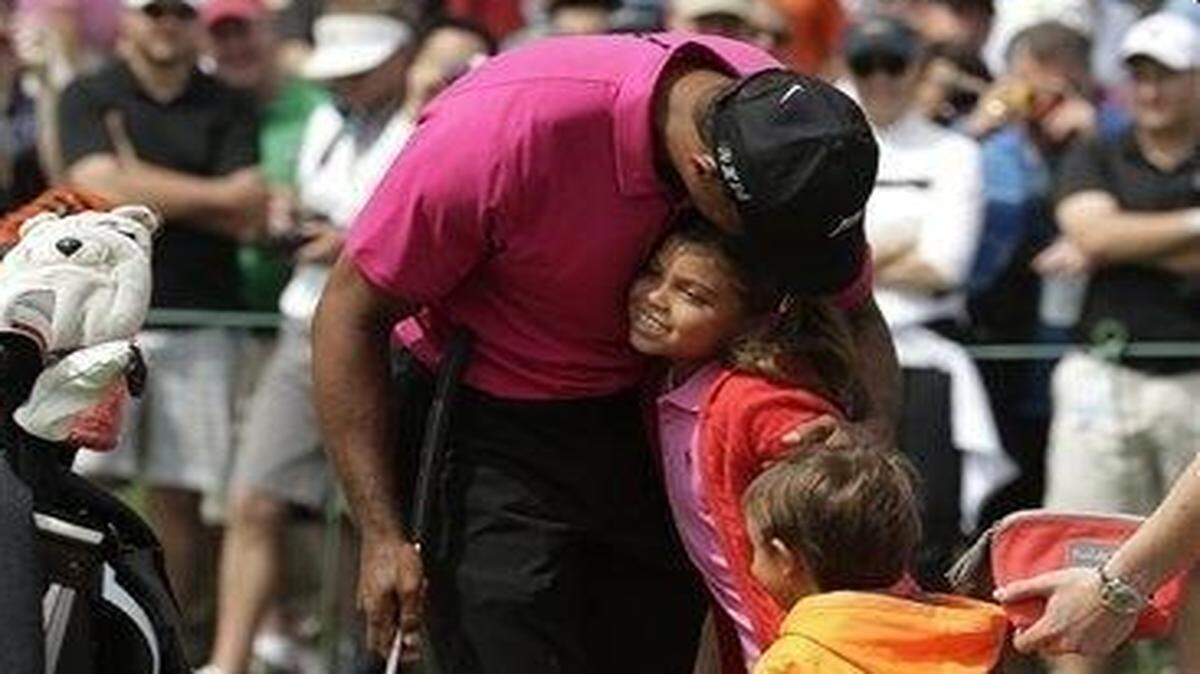 
Tiger Woods greets his children Charlie, left and Sam during a practice round for the Masters golf tournament Tuesday, April 7, 2015, in Augusta, Ga.
