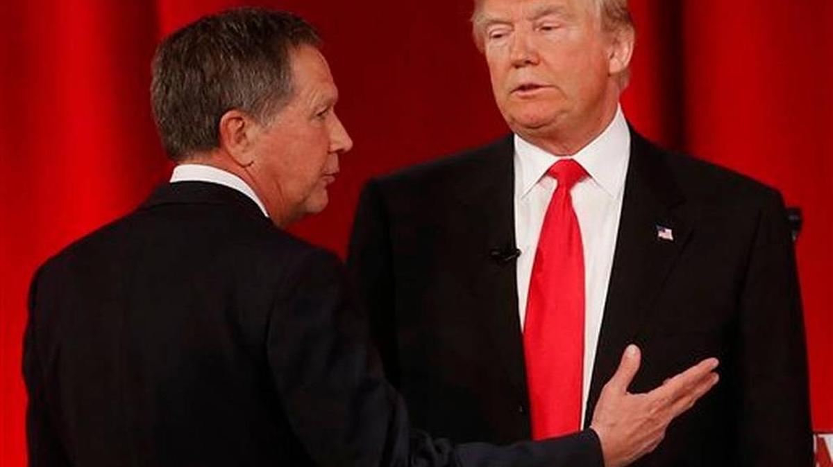Republican presidential candidate, Ohio Gov. John Kasich, left, speaks to Republican presidential candidate, businessman Donald Trump during a commercial break during the CBS News Republican presidential debate at the Peace Center, Saturday, Feb. 13, 2016, in Greenville, S.C.