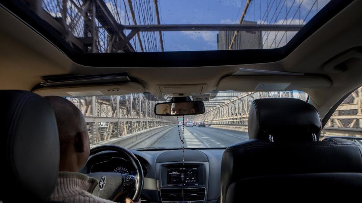 An Uber driver crosses the Brooklyn Bridge heading toward Manhattan in New York.