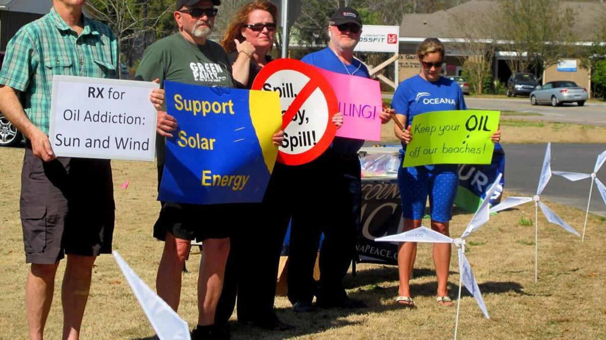 
Opponents of opening waters off the Carolinas coast to oil and natural gas exploration hold signs during a March 2015 protest in Mount Pleasant, S.C. They were standing outside a motel where the federal Bureau of Ocean Energy Management held a meeting to take public comment. The views of the five coastal congressmen in the Carolinas differ in states where the governors are strong advocates of offshore drilling and where 18 coastal communities have gone on record against it. (AP Photo/Bruce Smith, file)
