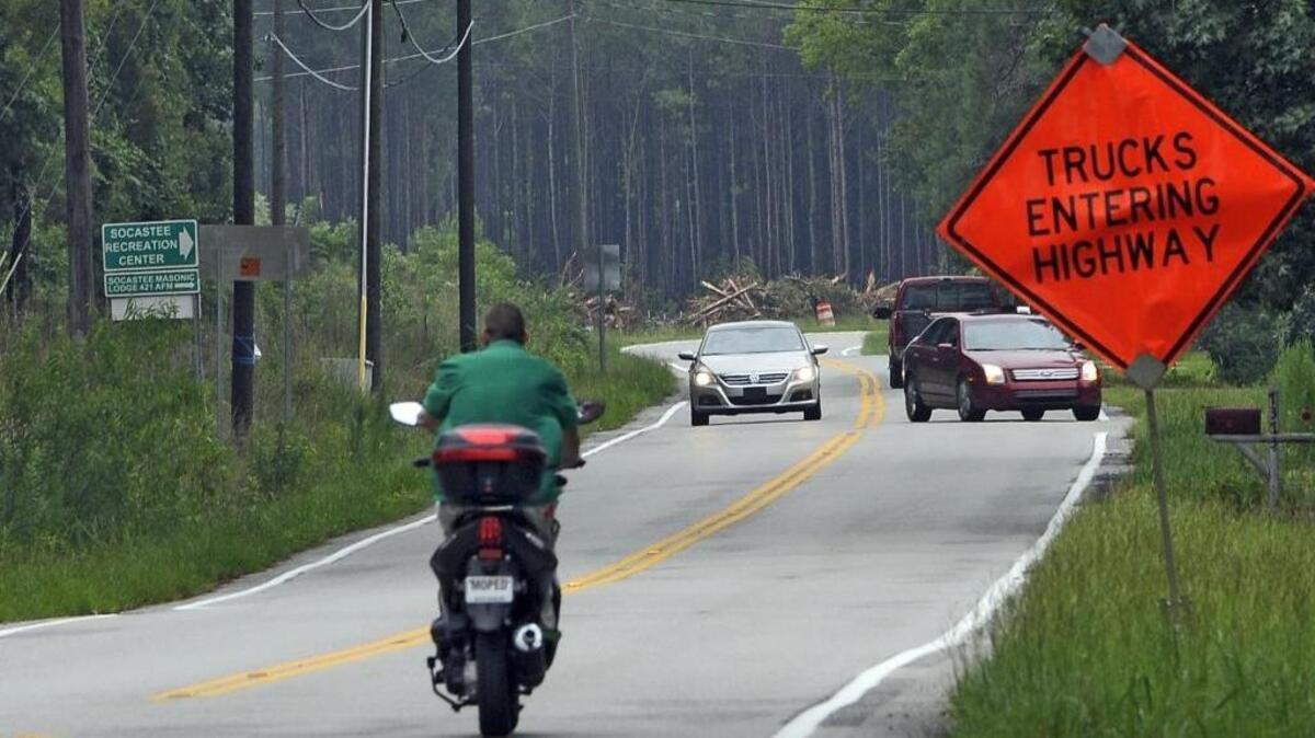 
A mo-ped driver makes his way down Enterprise Road in this 2014 file photo.
