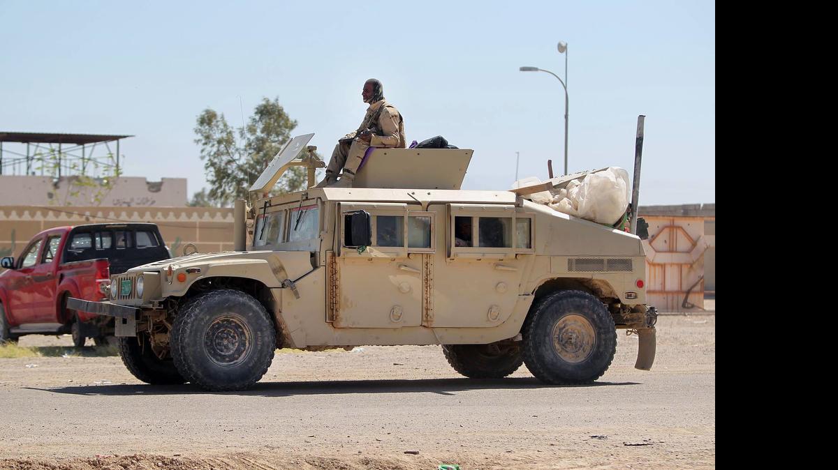 
In this April 26, 2015 photo, Iraqi security forces patrol during an operation against Islamic State group militants, to retake the water control station on a canal lost over the weekend, in the town of Garma, between Baghdad and the Islamic State-held city of Fallujah, Iraq. (AP Photo)
