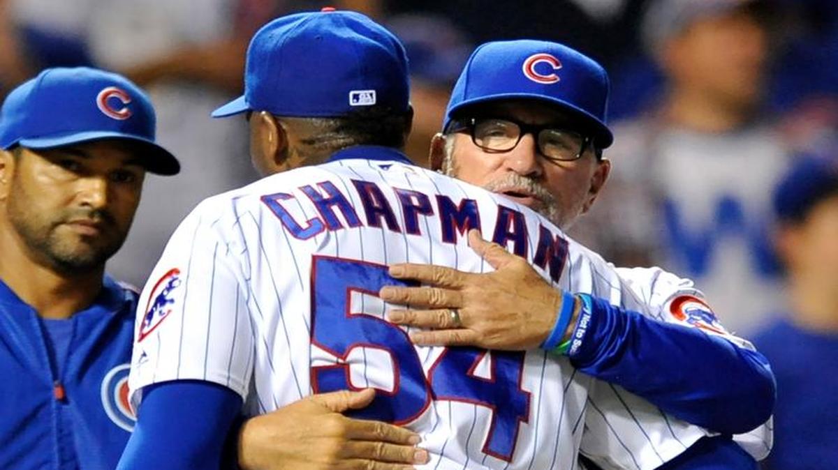 Then-Chicago Cubs closing pitcher Aroldis Chapman (54) celebrates with manager Joe Maddon in September.