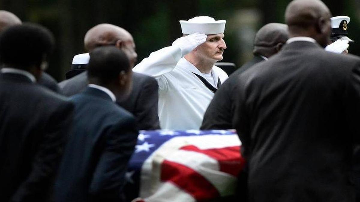 
LS1 John Miller salutes the casket of Navy veteran Reuben Hoskin at a recent funeral in Charlotte. Charlotte's Naval Operational Support Center or NOSC base is the home for the naval Funeral Honors detail. They help conduct hundreds of funerals every year and LS1 John Miller has been involved in about 600 ceremonies. On Friday October 3, 2014 they'll play taps and present the flag to Lula Hoskin, the wife of Naval veteran Reuben Hoskin.

