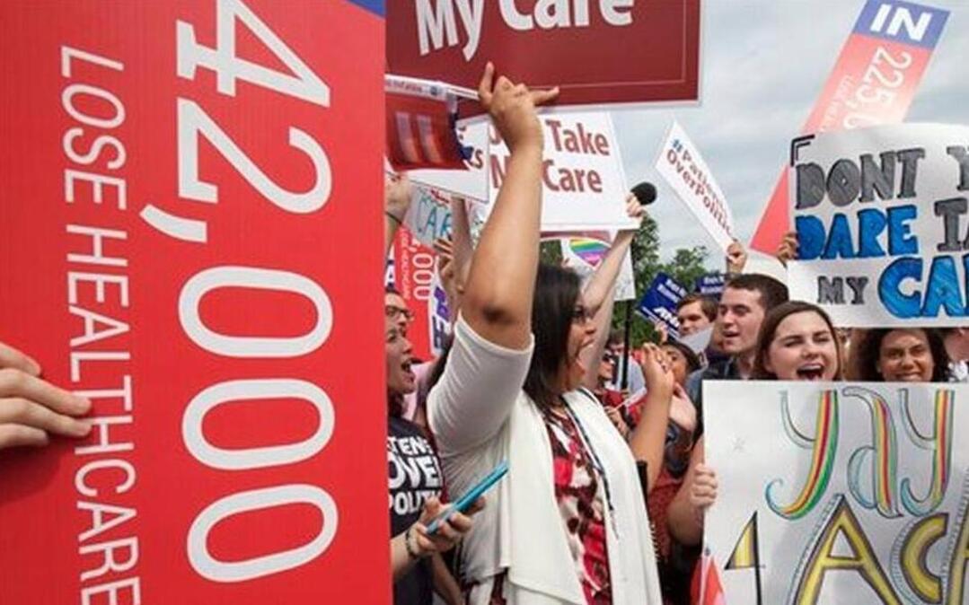 
Jessica Ellis, right, with "yay 4 ACA" sign, and other supporters of the Affordable Care Act, react with cheers as the opinion for health care is reported outside of the Supreme Court in Washington,Thursday June 25, 2015. The Supreme Court on Thursday upheld the nationwide tax subsidies under President Barack Obama's health care overhaul, in a ruling that preserves health insurance for millions of Americans. | Jacquelyn Martin AP Photo

