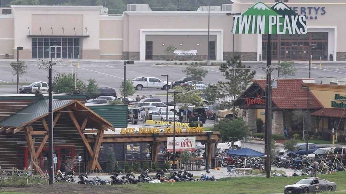 
Law enforcement investigate the motorcycle gang related shooting at the Twin Peaks restaurant, Monday, May 18, 2015, in Waco, Texas, where 9 were killed Sunday and over a dozen injured. Waco police on Monday announced the Texas Alcoholic Beverage Commission closed Twin Peaks for a week amid safety concerns. | Jerry Larson AP
